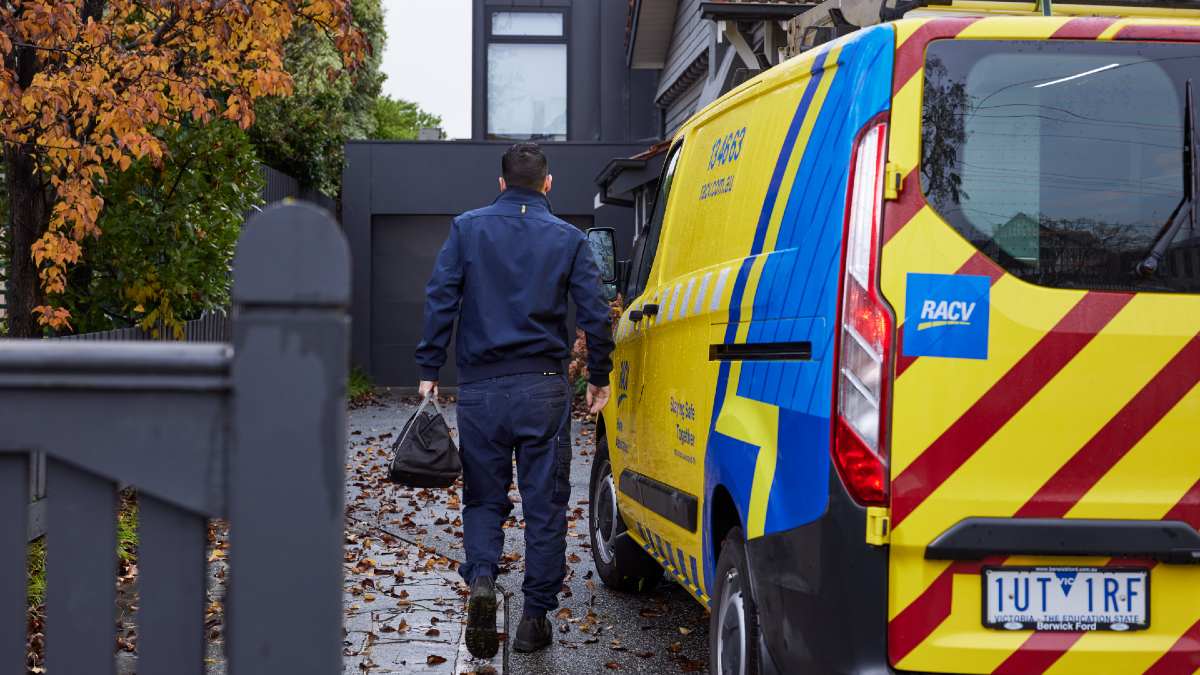 RACV EHA worker walking from van to house with toolbag