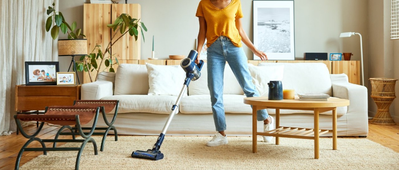 vacuum Woman vacuuming living room