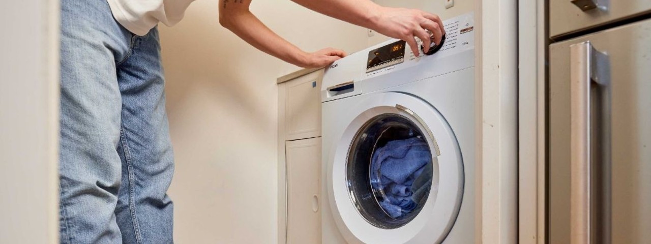 man loading a washing machine