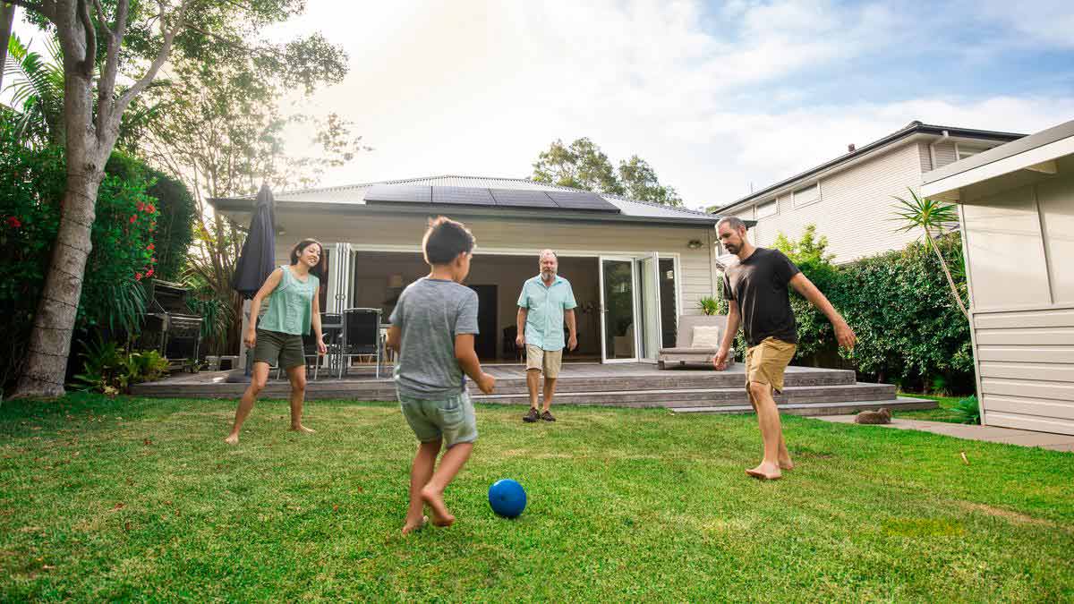 family playing in backyard