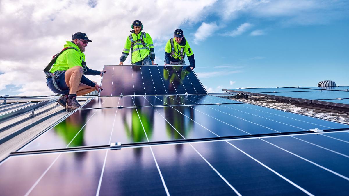 three RACV Solar technicians installing solar panels