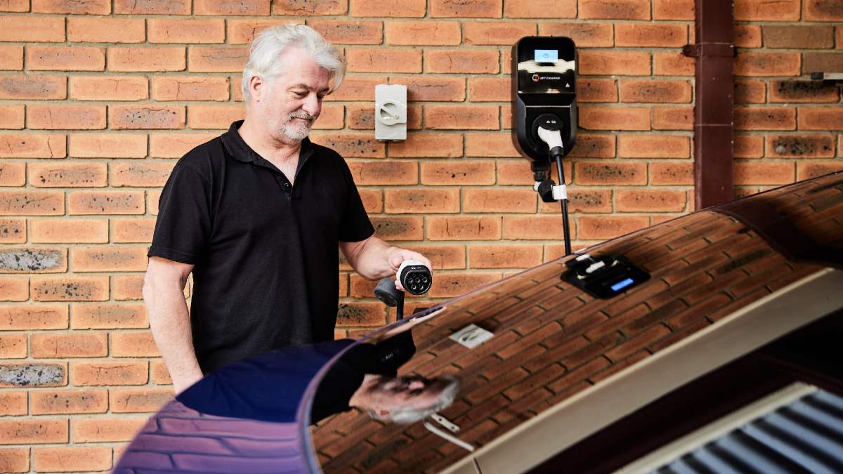 man charging his EV at home