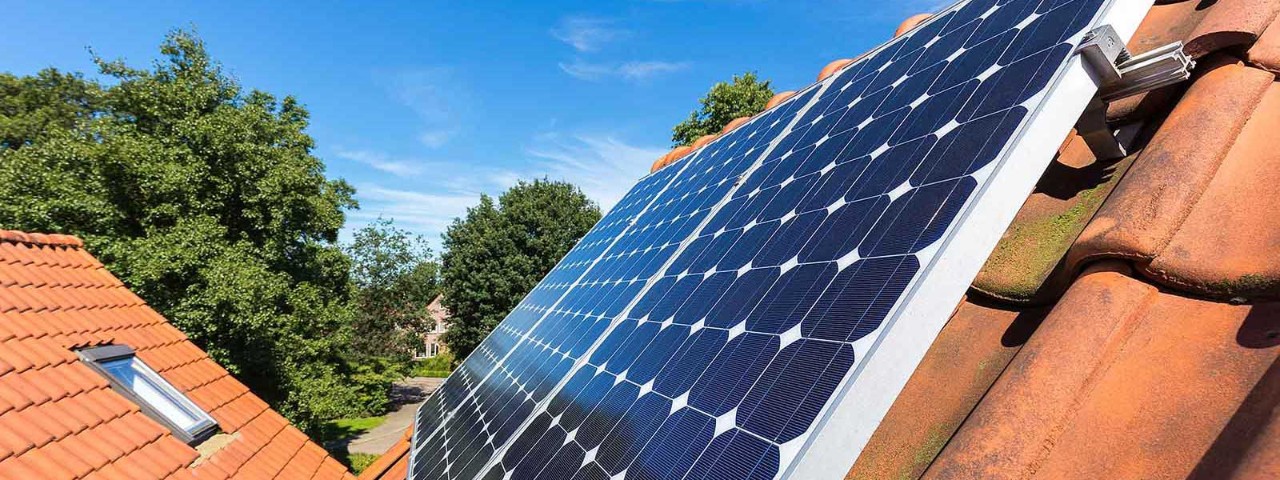 1069245432 Solar panels on red-tiled roof