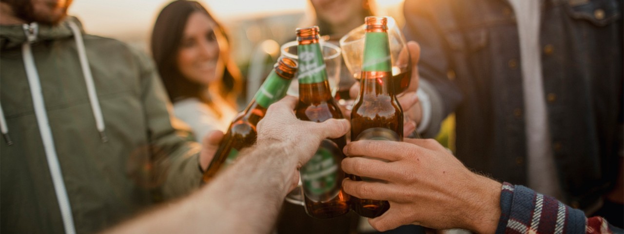 883100078 People clinking glass beer bottles