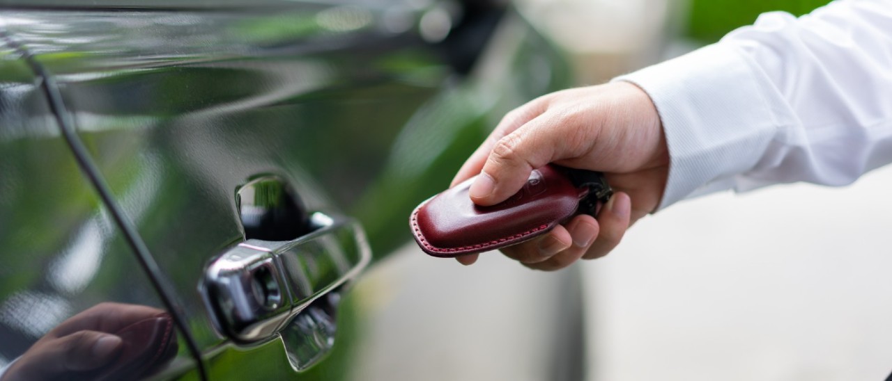 person locking car with remote fob