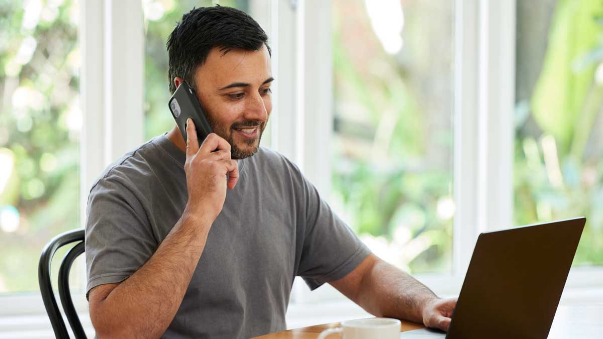 Person on phone and laptop
