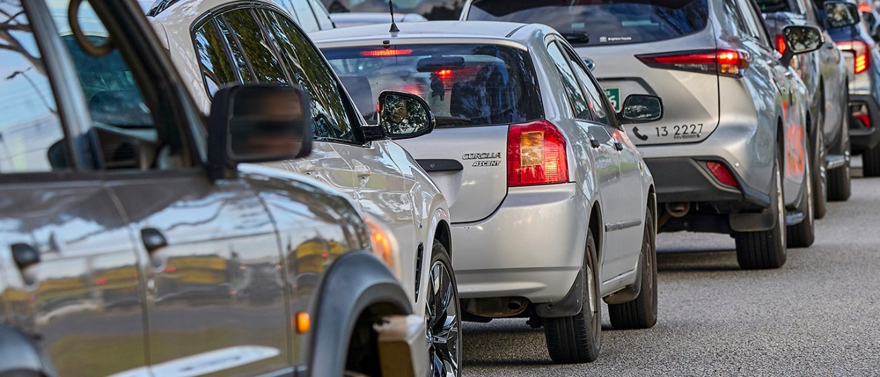 Cars in a row at traffic lights.