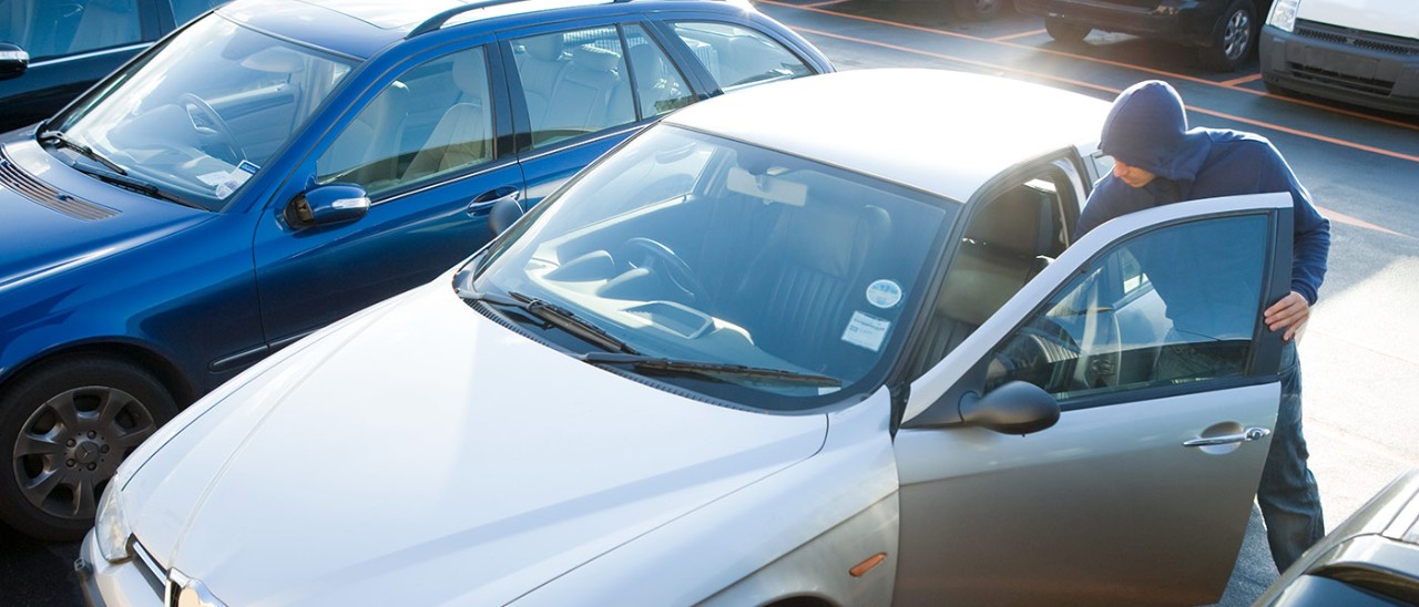 Man breaking into car in carpark