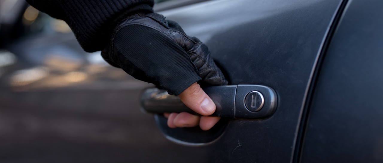 car thief opening car door