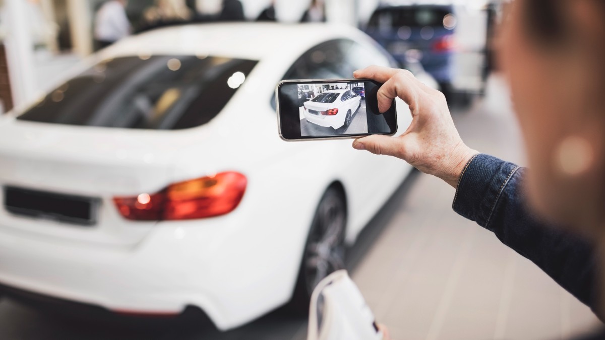 person taking a photo of a car for sale