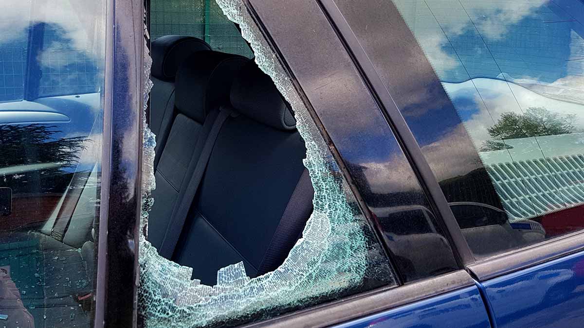 Side window of blue car smashed.