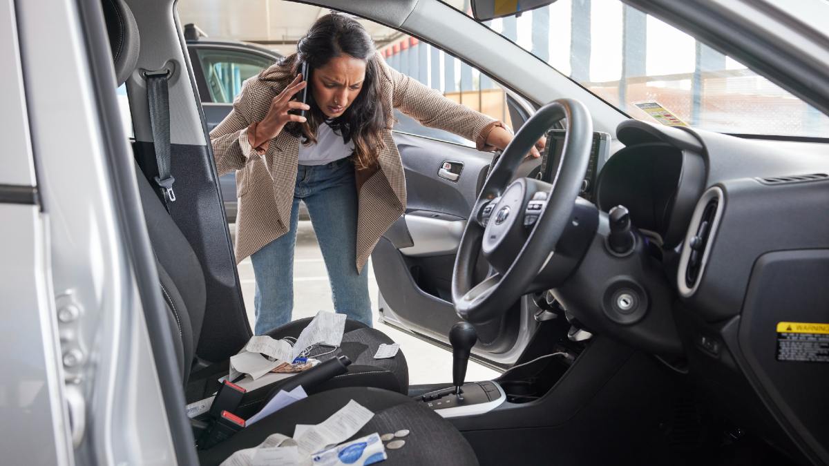 woman calling insurance looking at her car break-in
