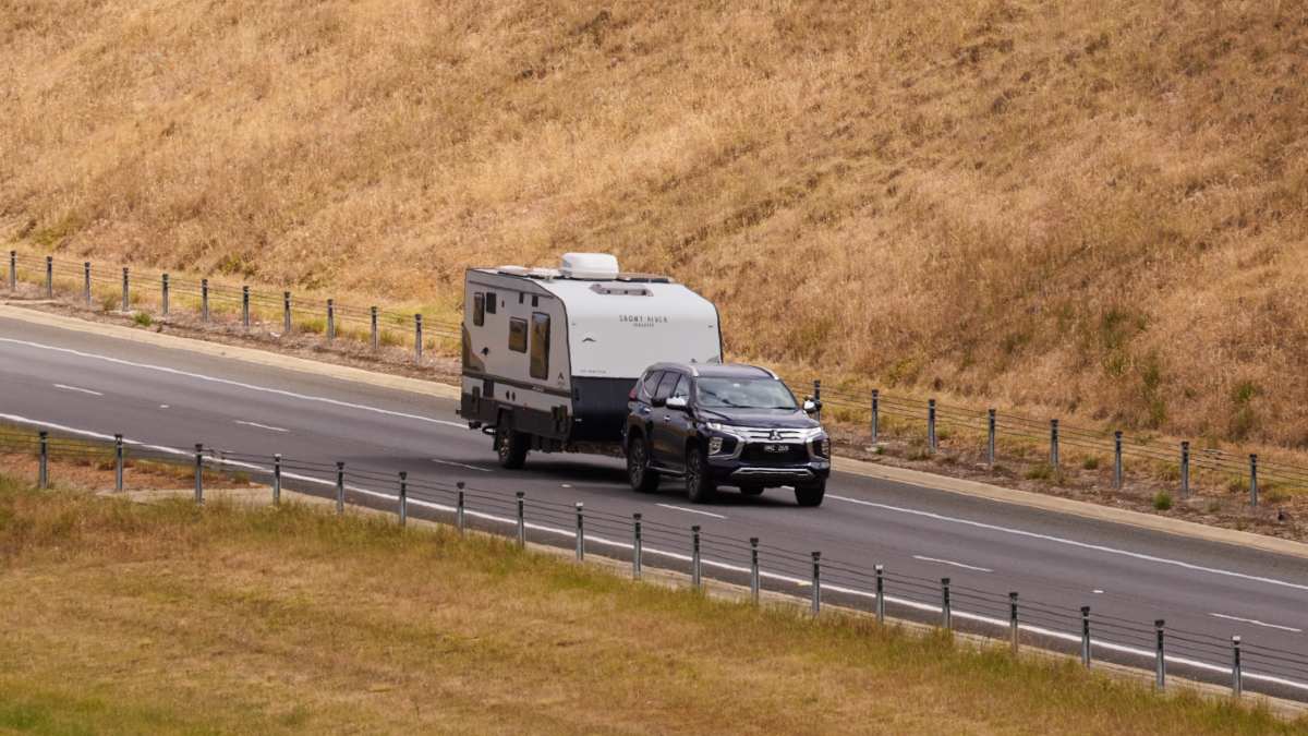 SUV towing caravan on highway