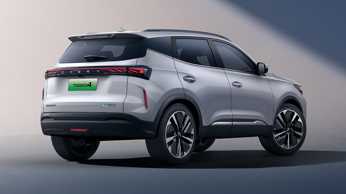 Rear quarter view of silver metallic Chery Tiggo 4 Hybrid small SUV in studio showing LED tail-lights across rear end