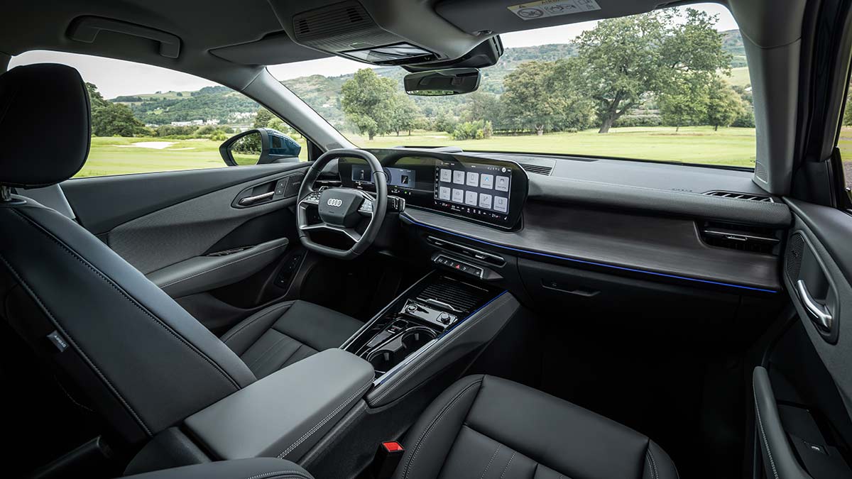 Front compartment of Audi Q3 small SUV with premium trim and horizontal dash design with curved digital displays.