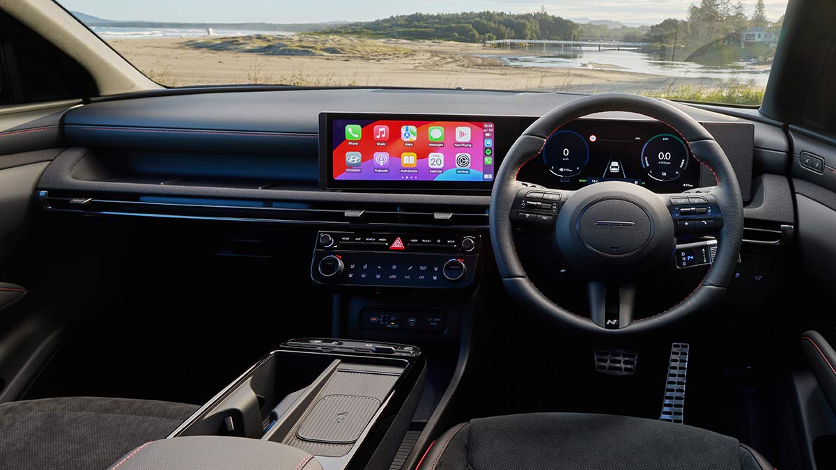 Dashboard of Hyundai Tucson Premium N Line Hybrid SUV parked on sand near beach and river