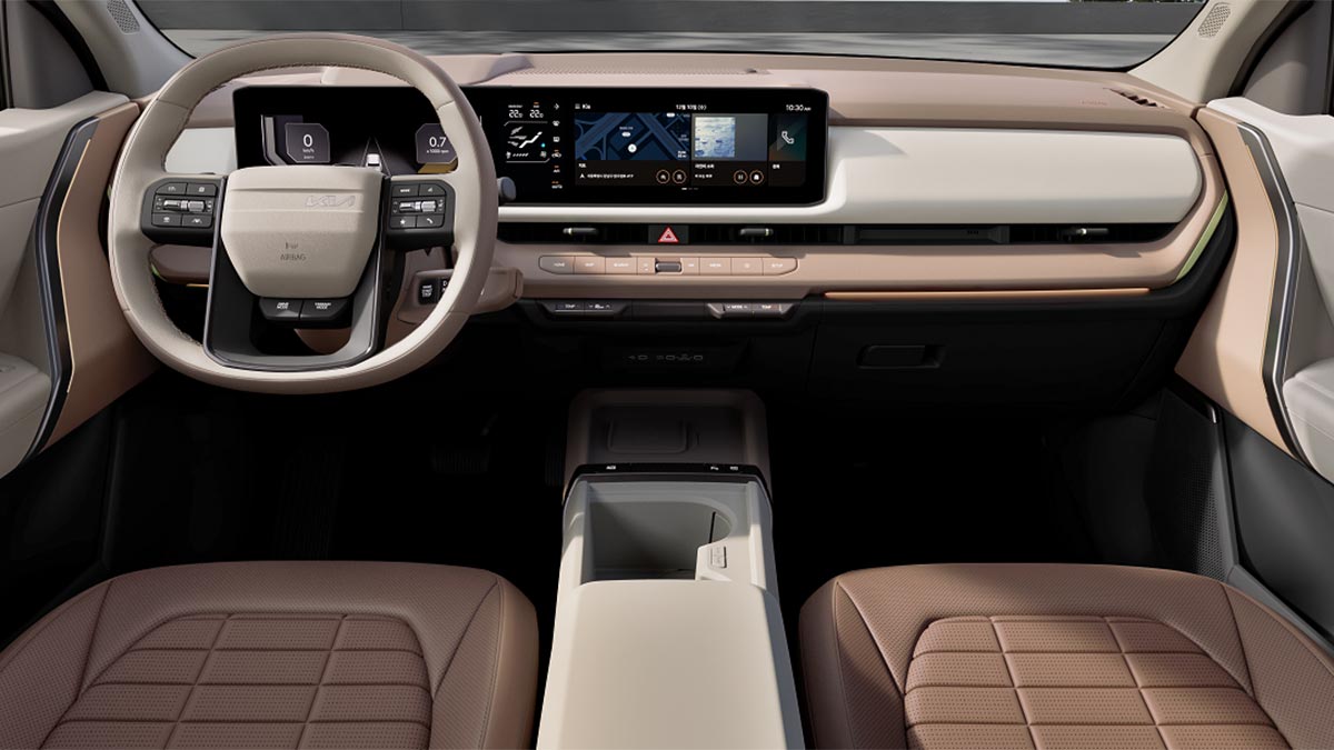 Two-tone cream and flesh-toned dashboard of Kia Seltos SUV with wide dual digital screens.