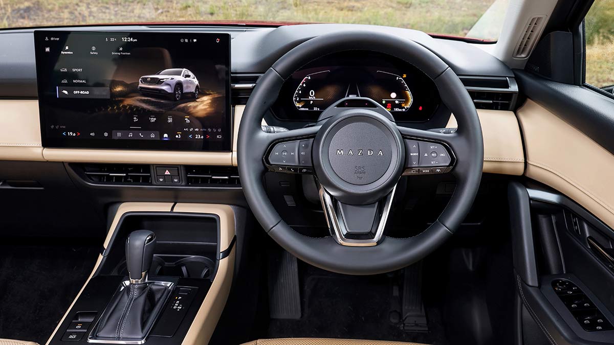 Black leather steering wheel, digital driver’s screen and large 15.6-inch central touchscreen in Mazda CX-5 Akera SUV.