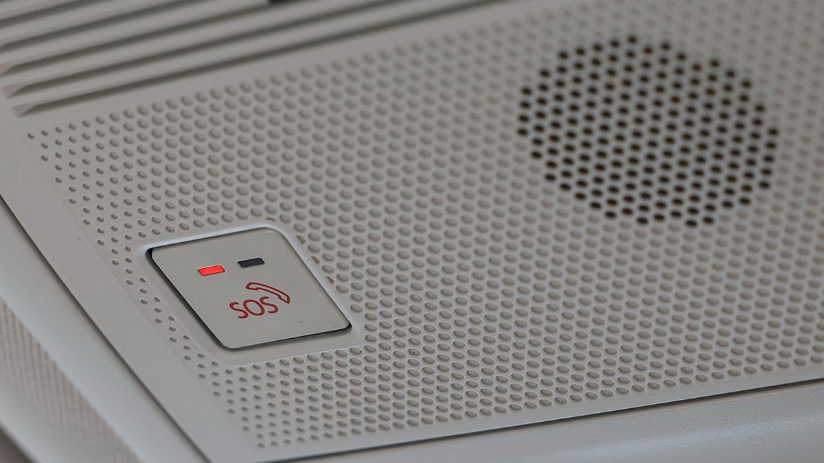 SOS button and speaker on overhead console in Mazda CX-5 SUV for emergency collision notification system.