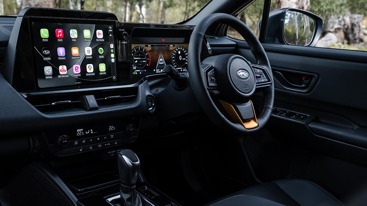 View of dashboard with new horizontal touchscreen and digital instrument display in Subaru Outback Wilderness parked in bush setting.