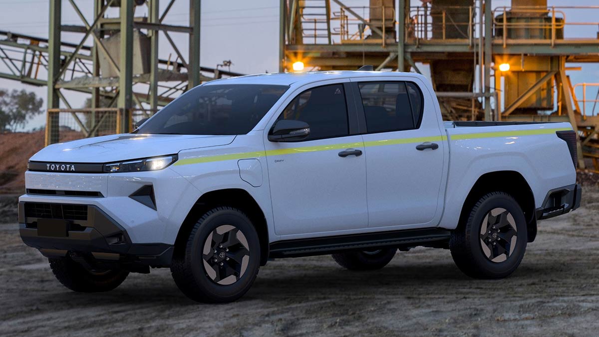 White battery-electric Toyota HiLux BEV dual-cab ute parked at industrial mining site.