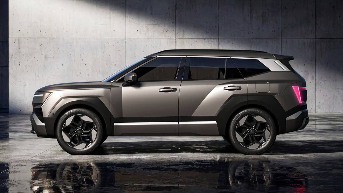 Side-on shot of grey metallic 2027 Hyundai Tucson SUV with boxy proportions and heavily sculpted body panels.