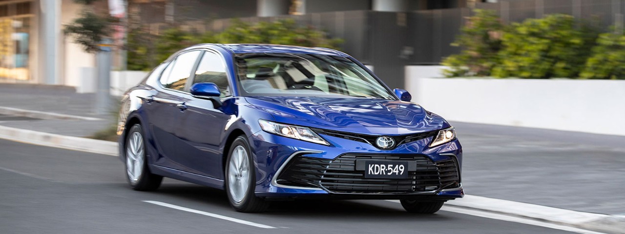 Blue Toyota Camry driving