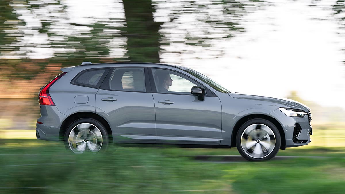 Grey 2021 Volvo XC60 T8 Recharge PHEV SUV driving in European countryside.