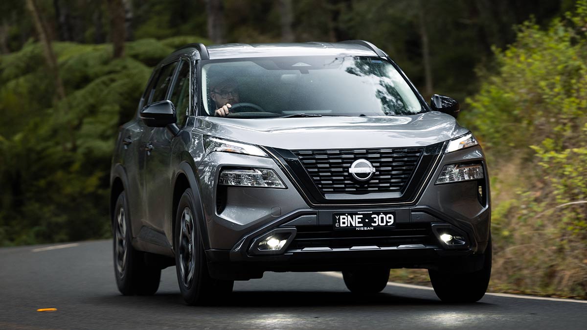 Silver Nissan X-Trail N-Trek on winding forest road