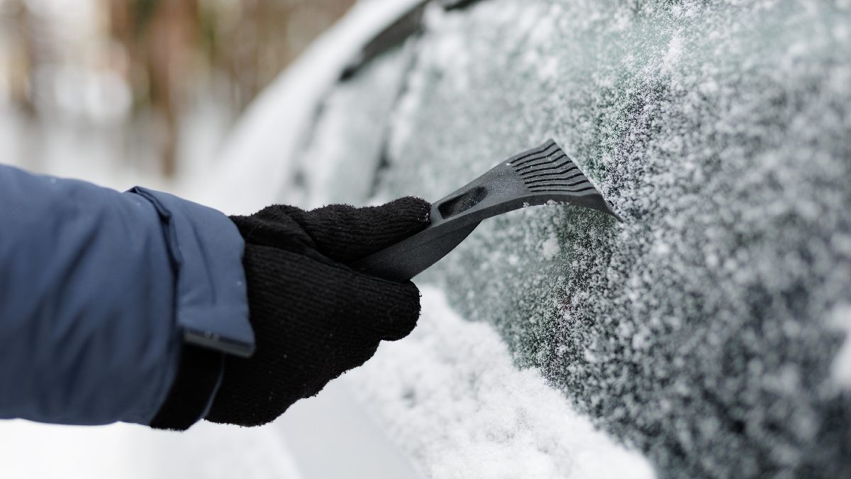 person using heater controls in car