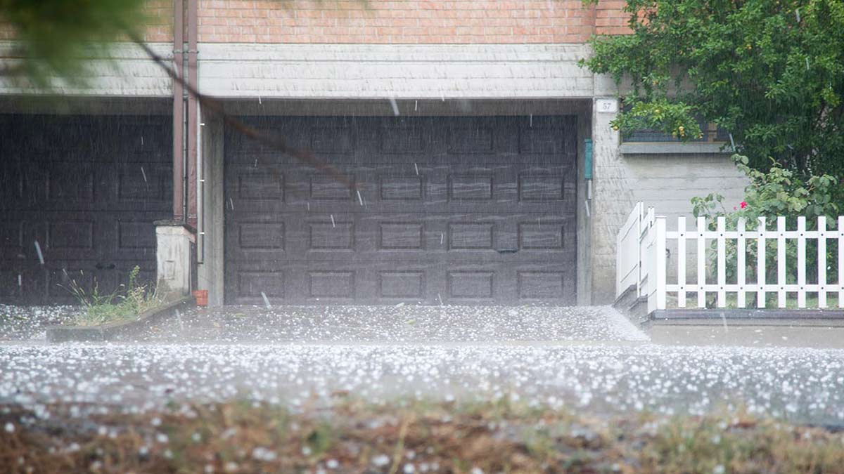 Hail on ground in front of garage.