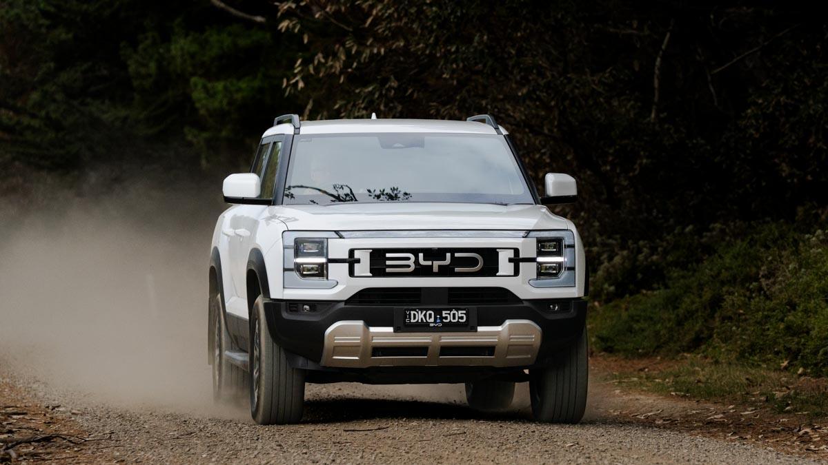 white 2025 BYD Shark 6 driving off-road