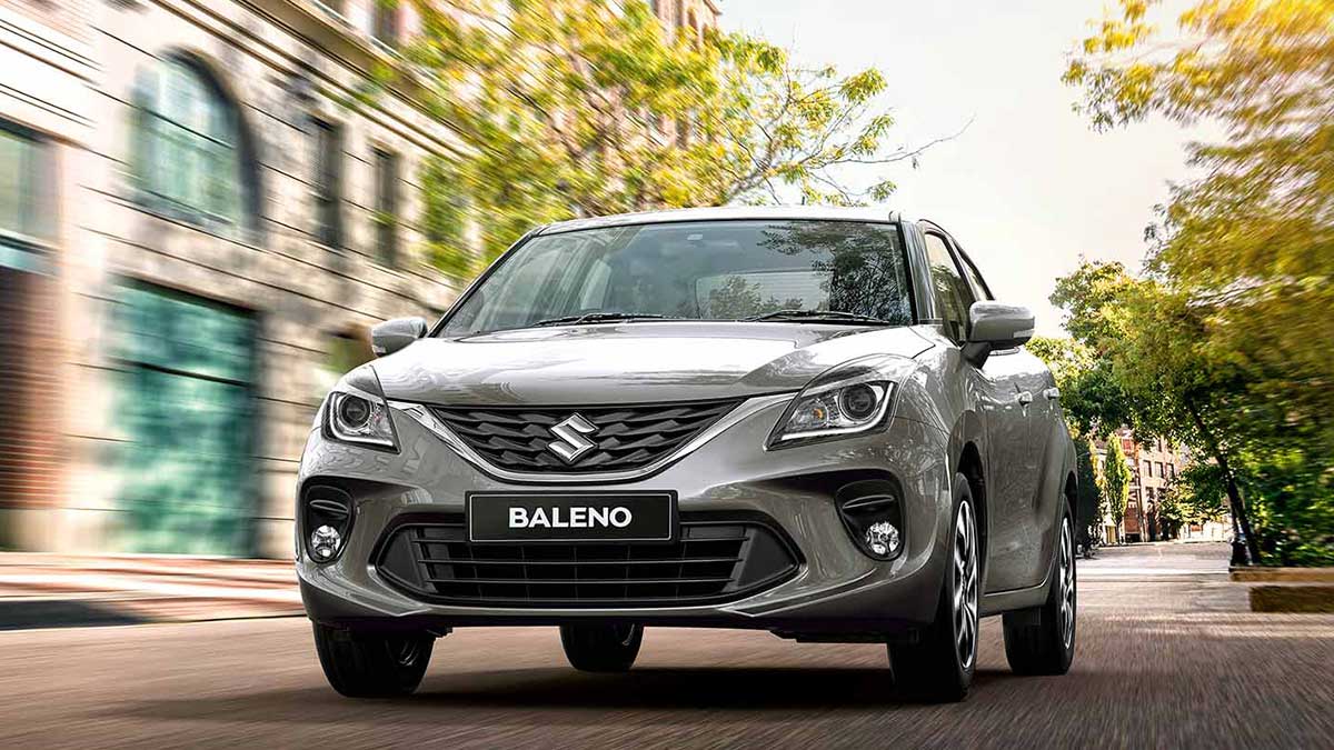 The Suzuki Baleno light hatchback driving along the road.