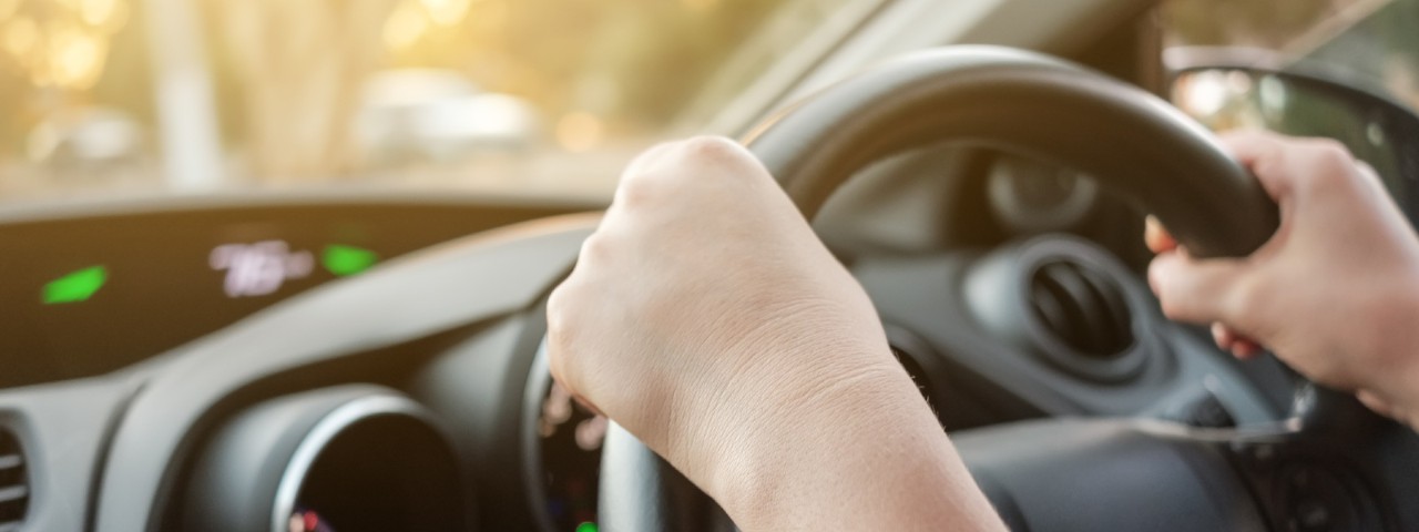 Person hands on wheel