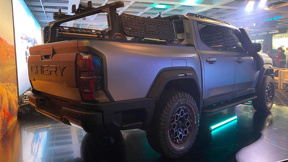 Rear view of silver design prototype of Chery KP31 ute at Sydney venue with green fluoro floor lights.