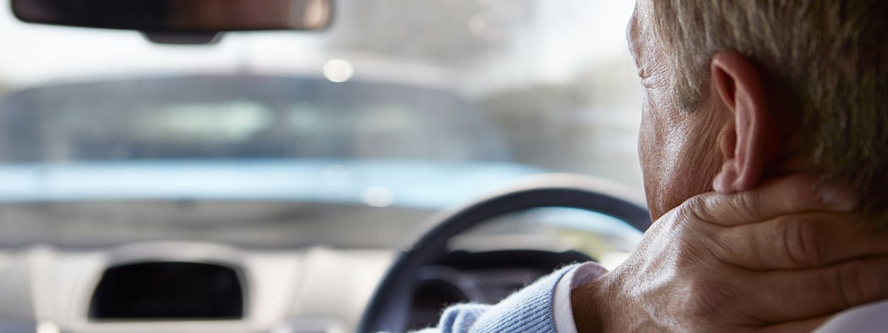Man driving with sore neck