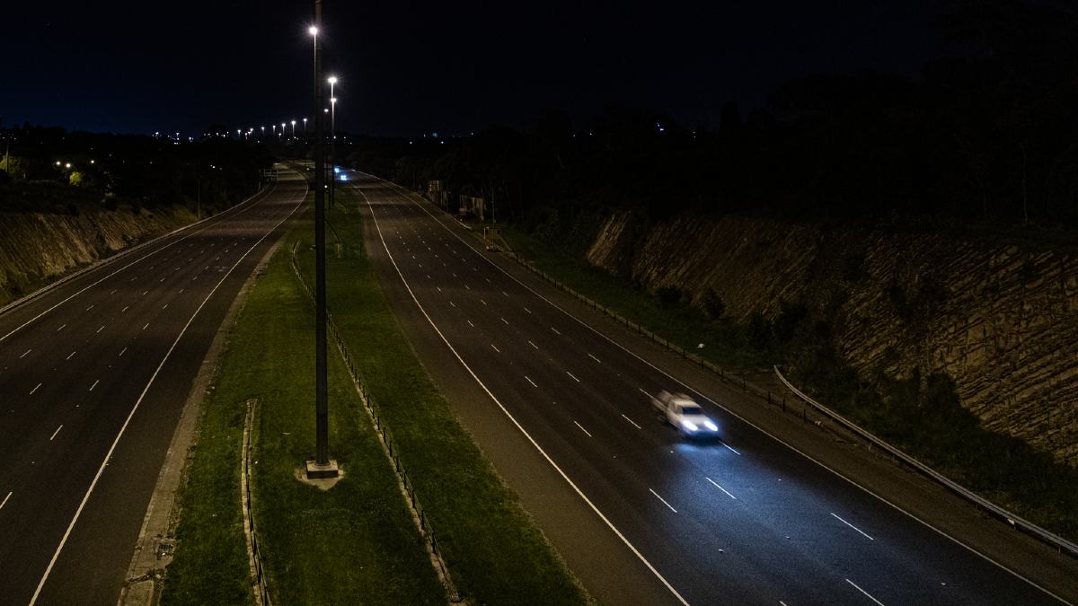 A ute driving along an empty highway in Melbourne at night