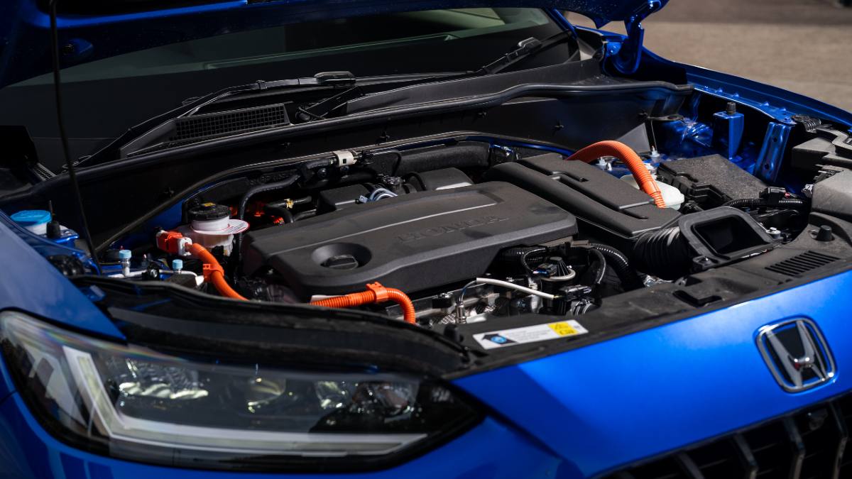 A blue Honda car with the bonnet lifted and engine visible