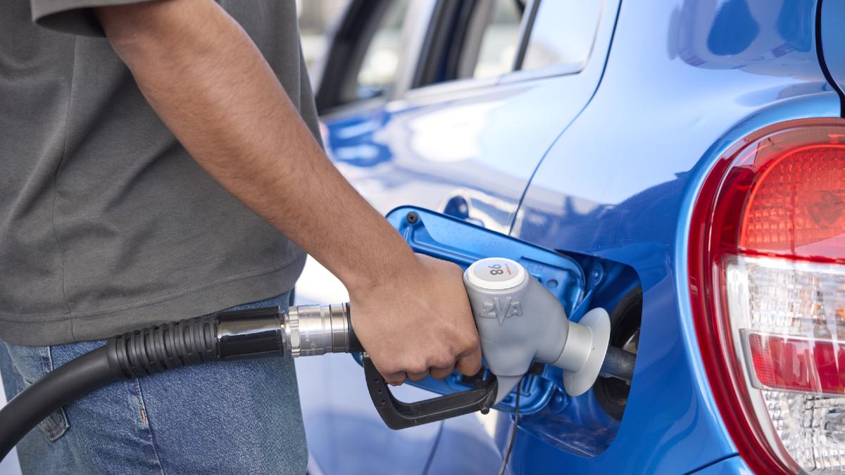 young man fuelling his car at a petrol pump