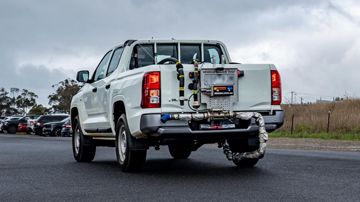 White Mitsubishi Triton dual-cab ute rigged up for real-world economy and emissions testing.