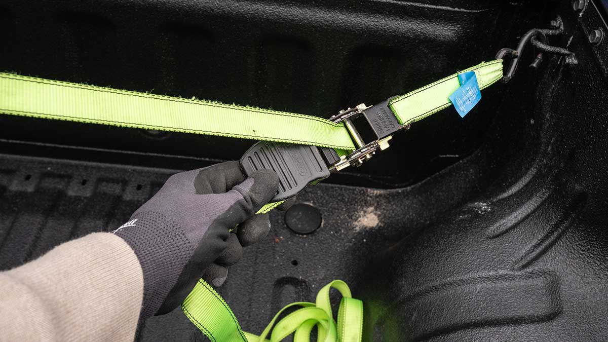 Close-up of ratchet strap being adjusted