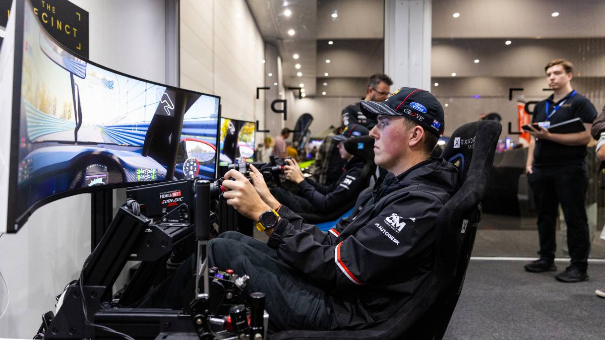 man playing a car game at a car show