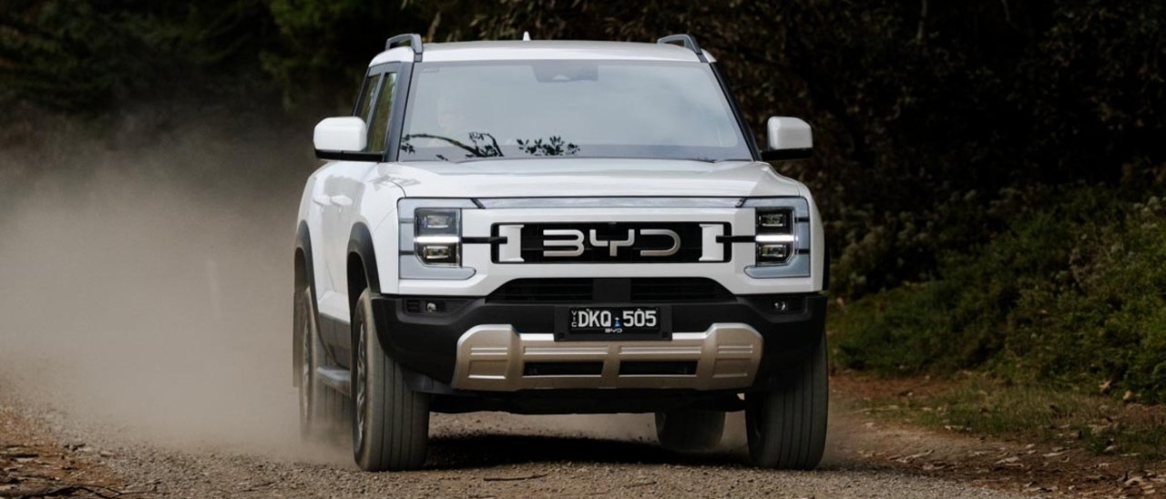 white 2025 BYD Shark 6 driving off-road