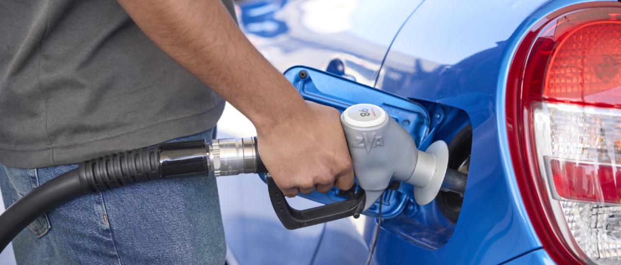 young man fuelling his car at a petrol pump