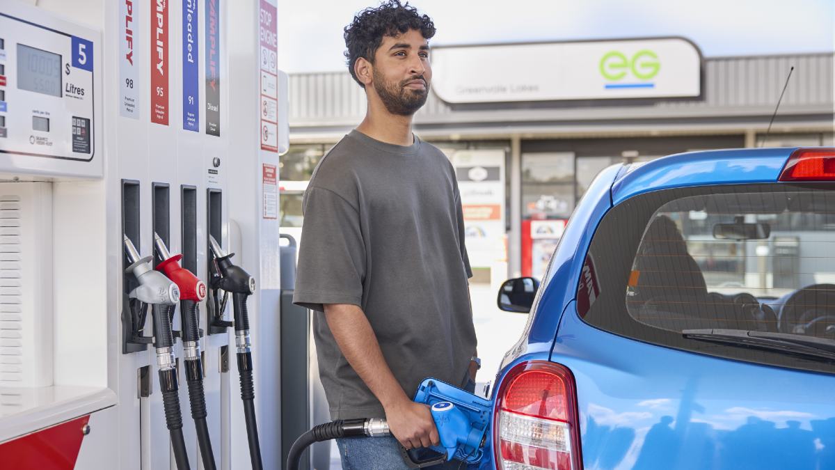 young man fuelling his car