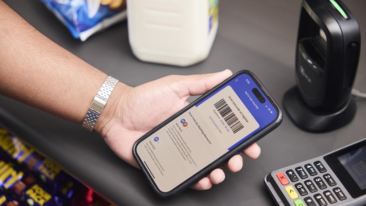 Someone showing a RACV App fuel voucher on their phone at an EFTPOS terminal