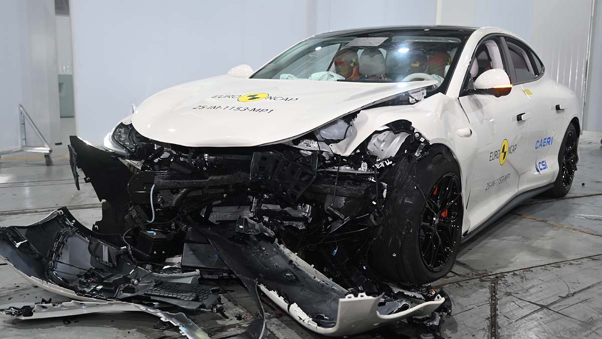 White MG IM5 sedan with heavily damaged front end after Euro NCAP frontal offset crash test.