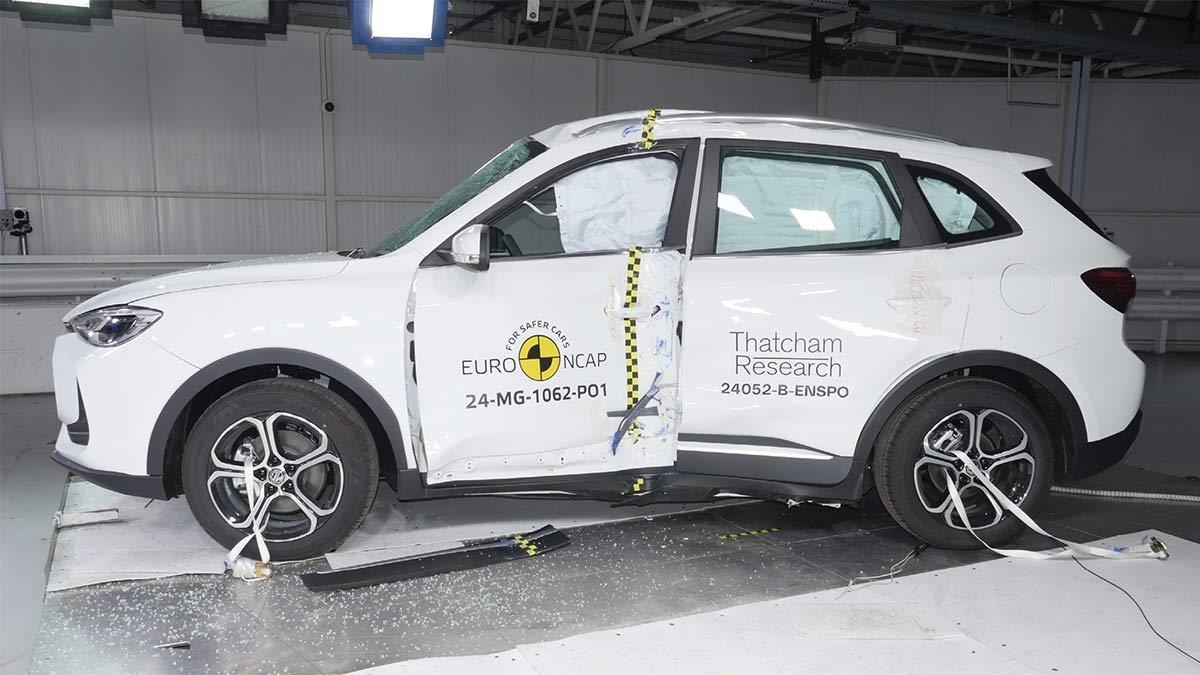 White MG ZS small SUV with curtain airbags deployed and damaged side panels after Euro NCAP side impact crash test.