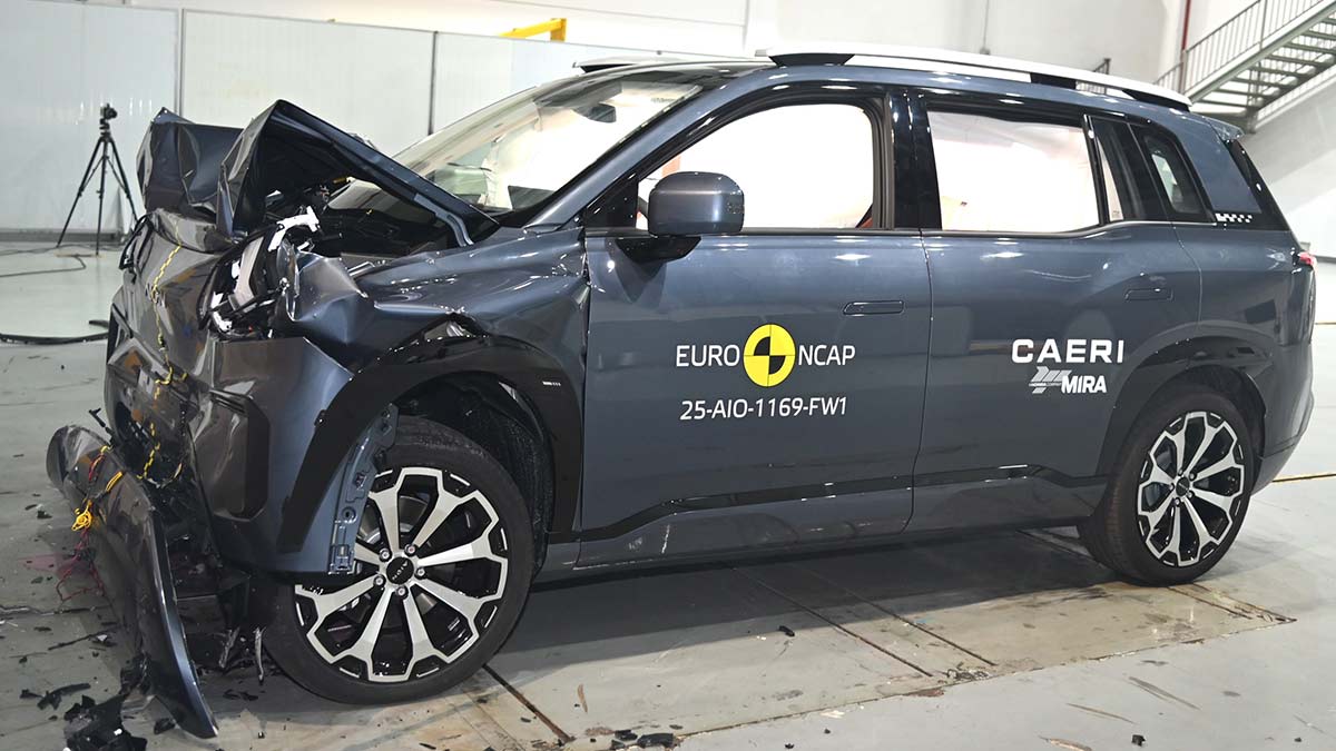 Dark grey GAC Aion V small SUV with heavily damaged front end and curtain airbags deployed after Euro NCAP frontal crash test.