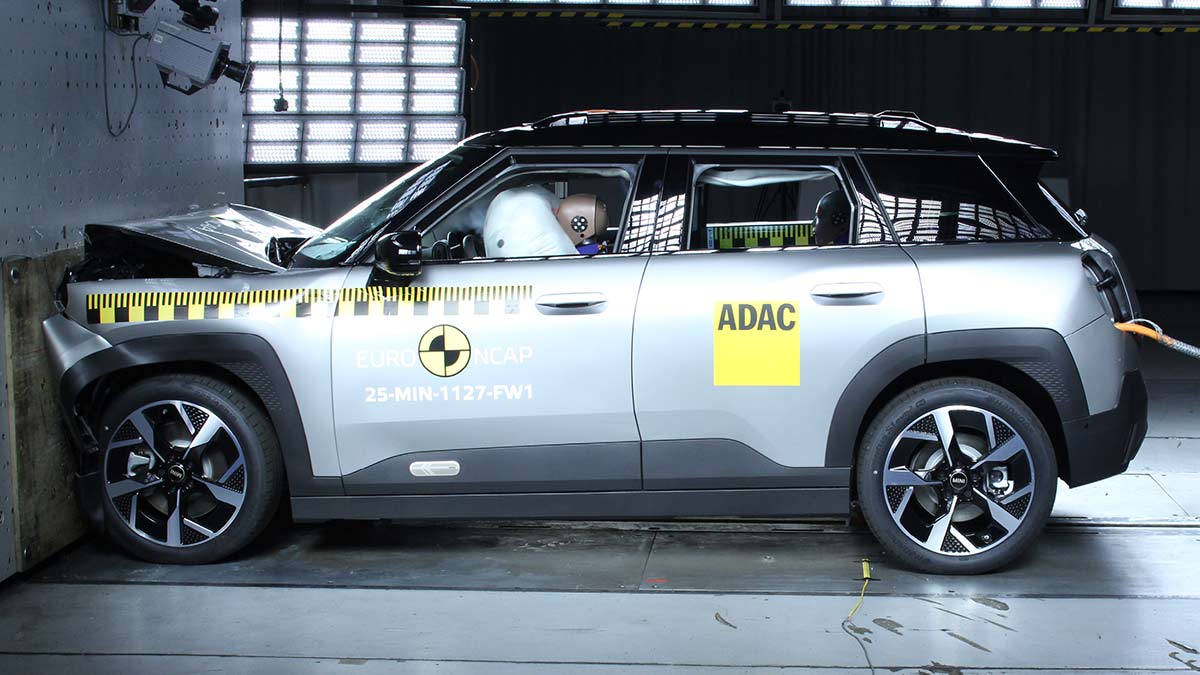 Silver Mini Aceman small SUV hitting wall front-on and dummy driver with face in airbag in Euro NCAP crash test.